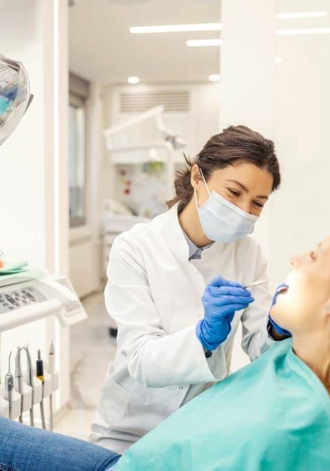 Friendly,Dentist,Examining,Patient's,Teeth,At,Dentist,Office. Dentist Near Me Sunnyvale